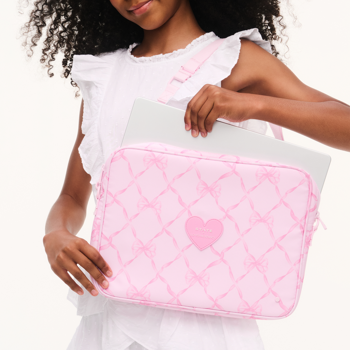 Girl wearing STATE x LoveShackFancy Allen Laptop Case
