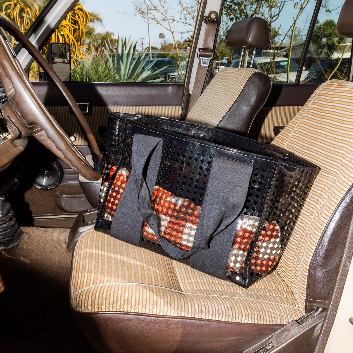 STATE Bags Wellington Cabana Tote Black Perforated sitting on car seat