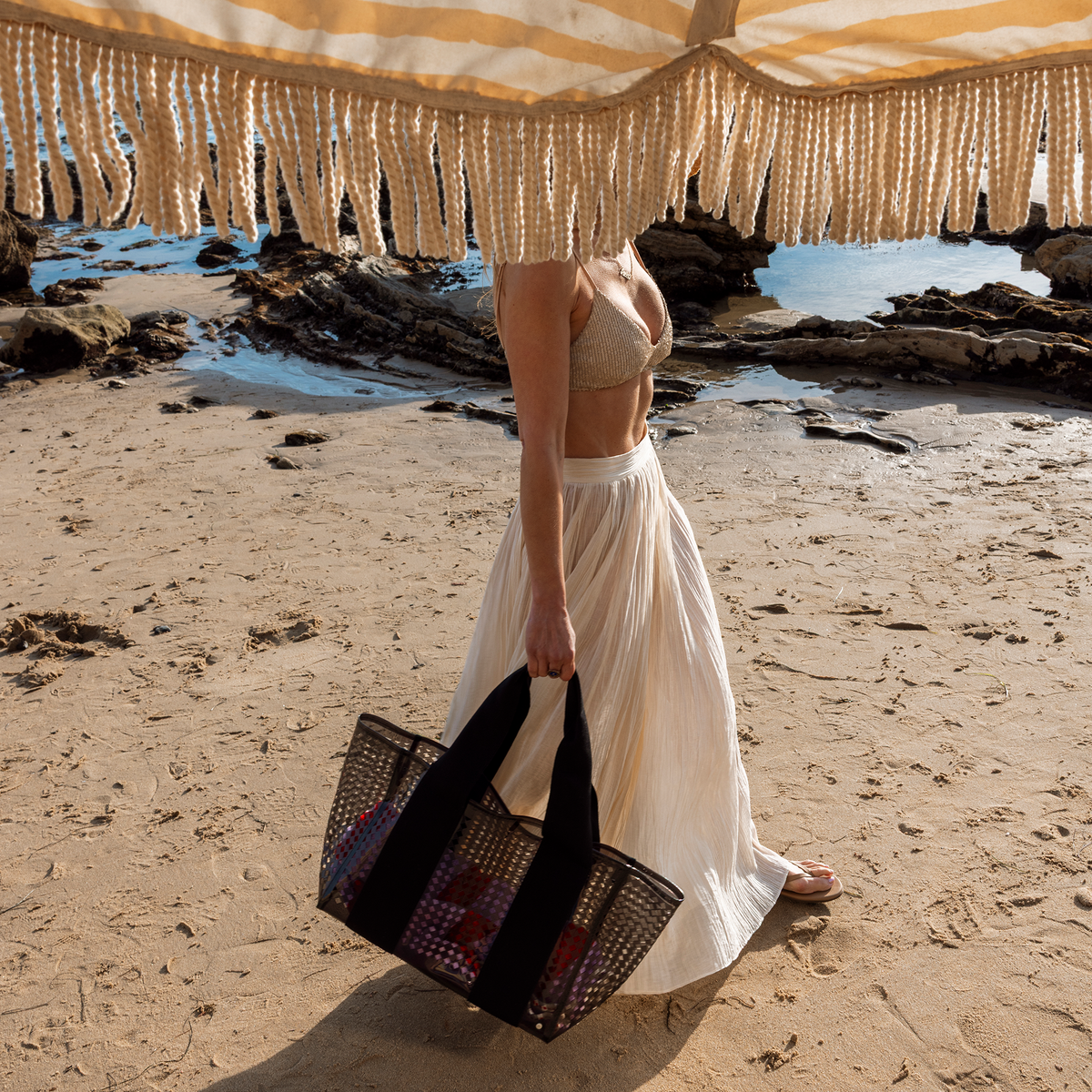 Woman holding STATE Bags Wellington Cabana Tote Black Perforated 