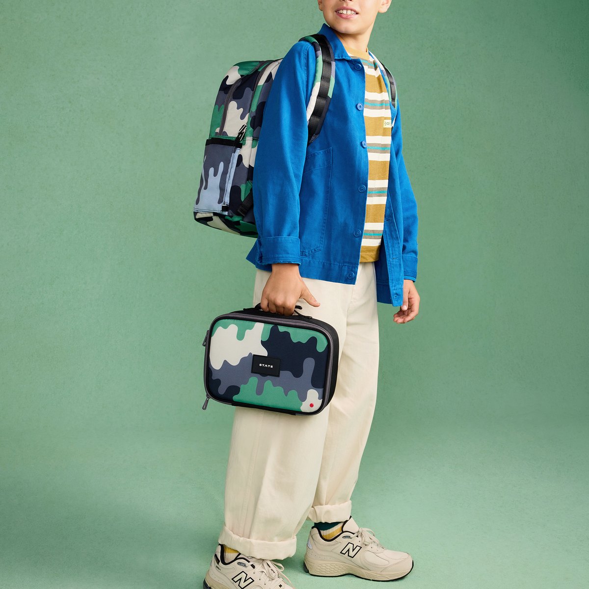 boy holding Rodgers Lunch Box camo drip