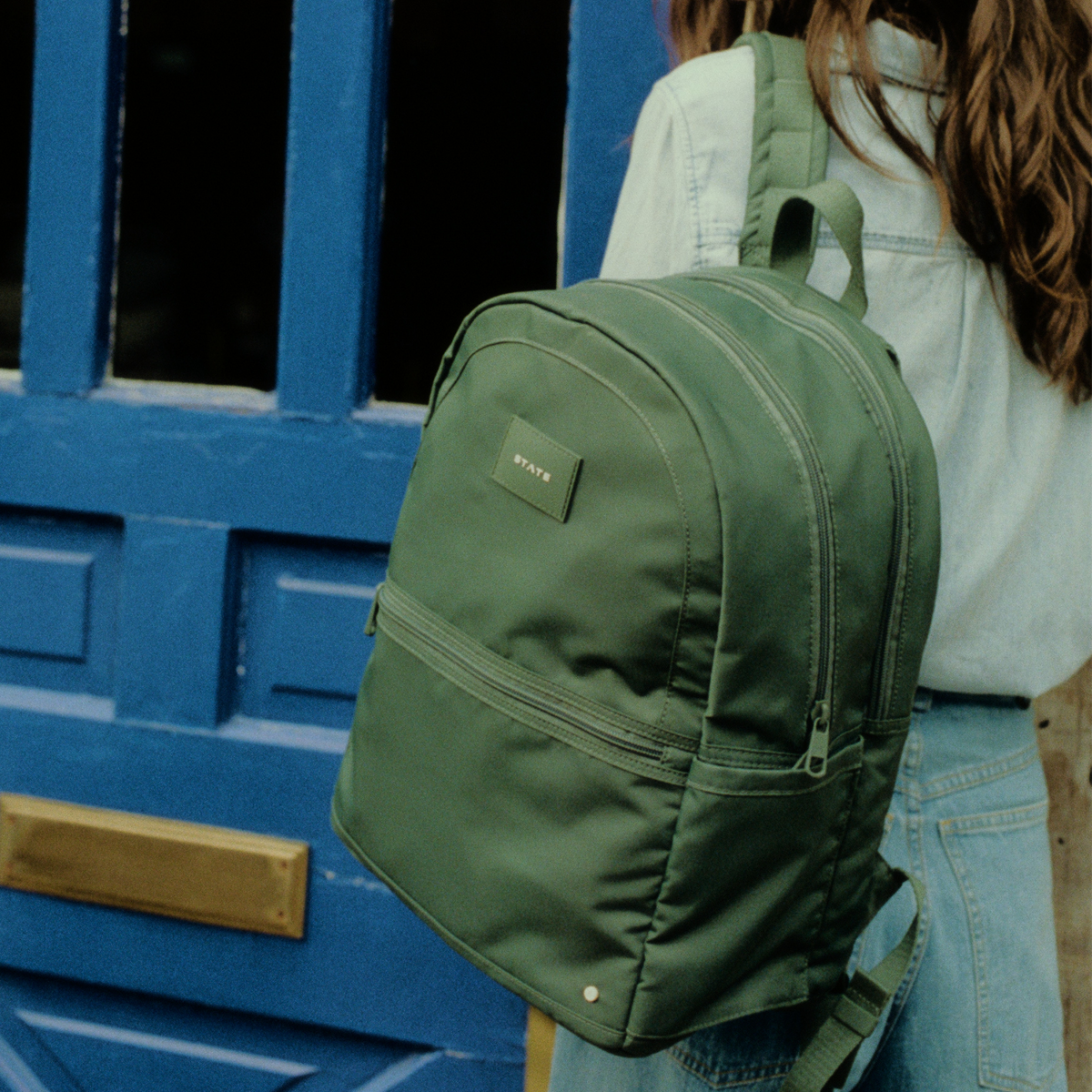 woman wearing STATE Bags Evans Double Pocket Olive 