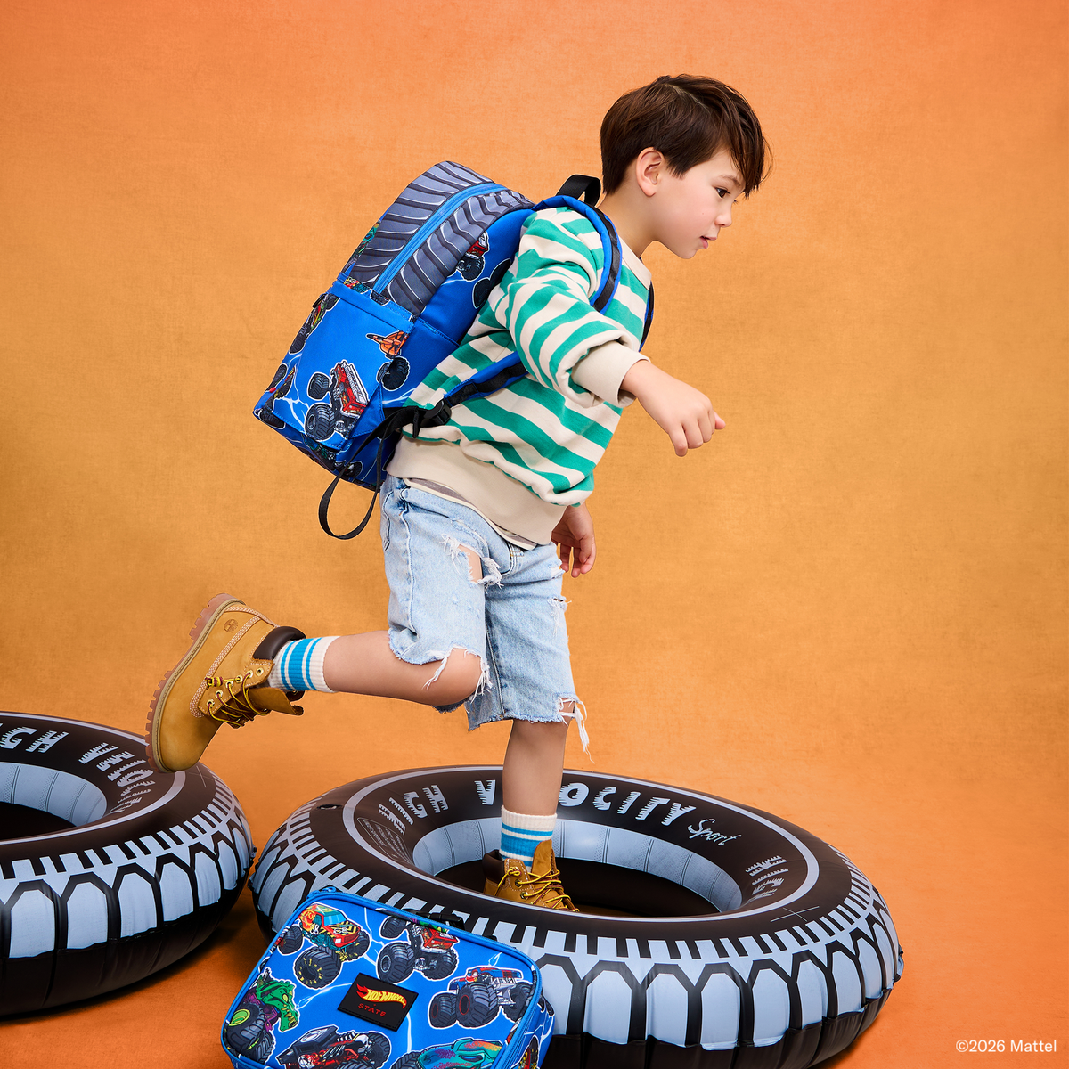 Boy wearing STATE x Hot Wheels™ Kane Backpack Falling Trucks