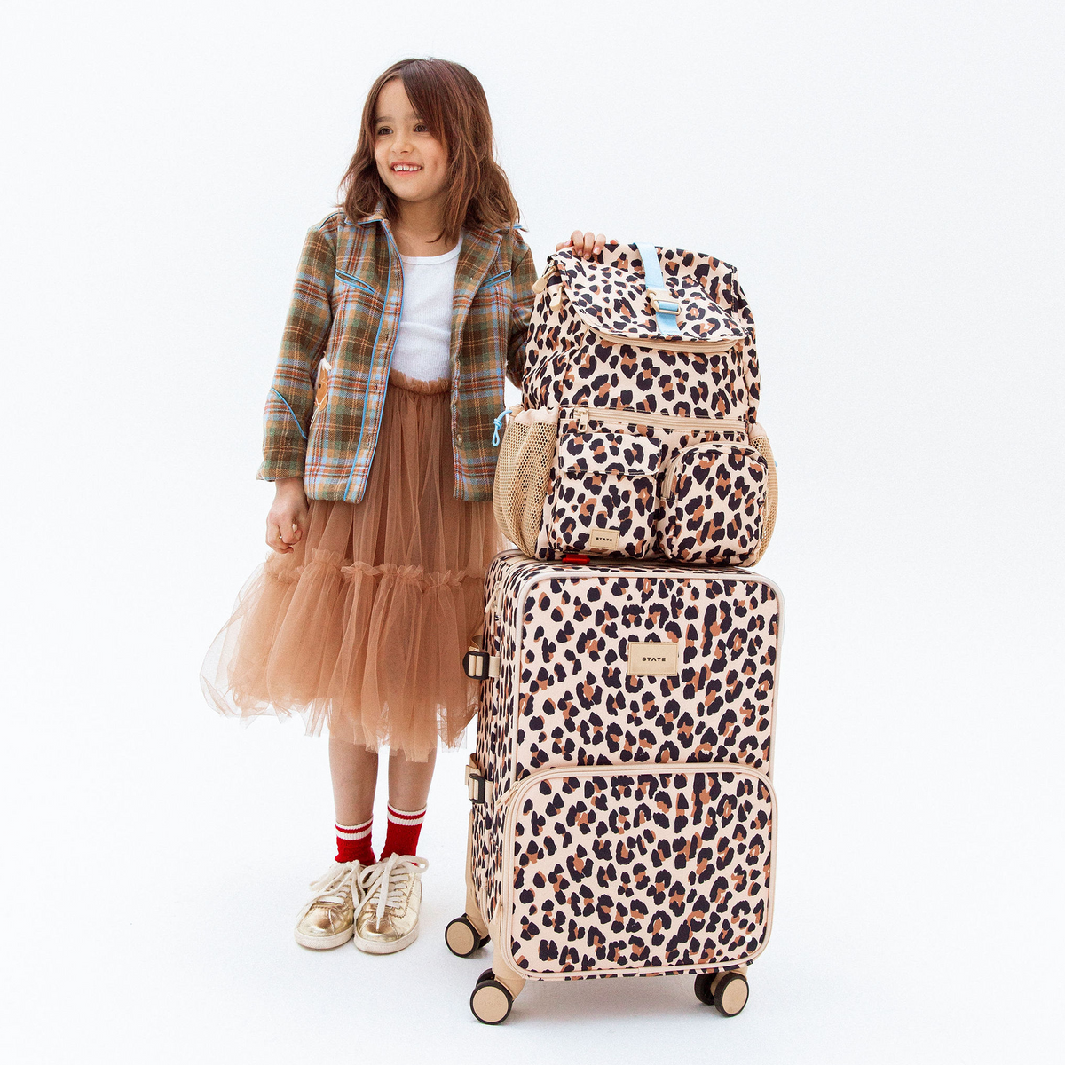 girl with STATE Bags Logan Carry-On Suitcase Leopard 
