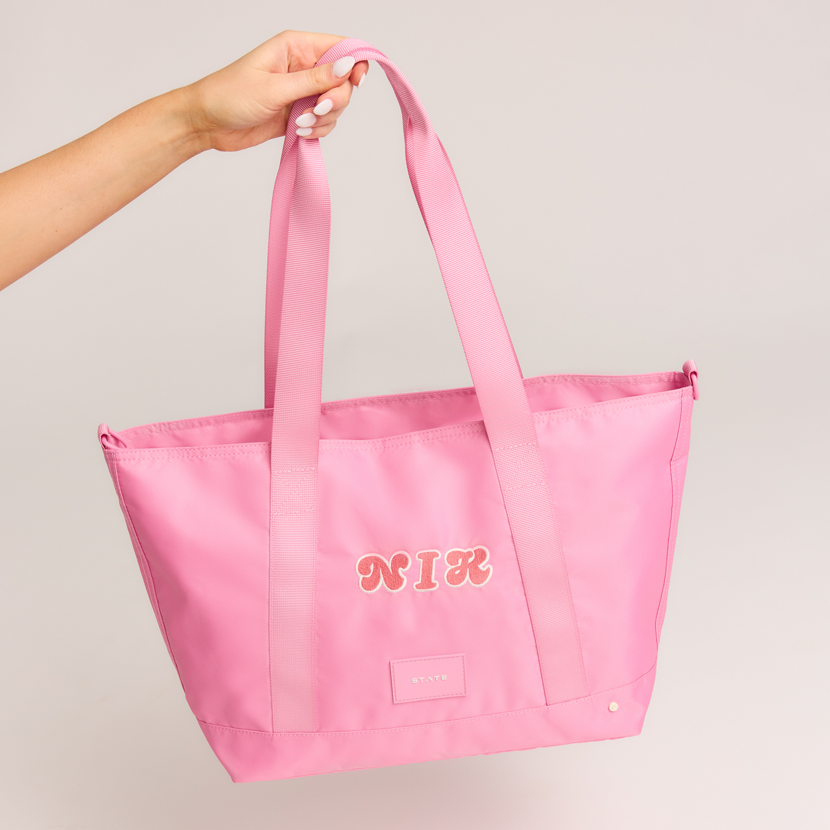 girl holding state bags graham totes in pink