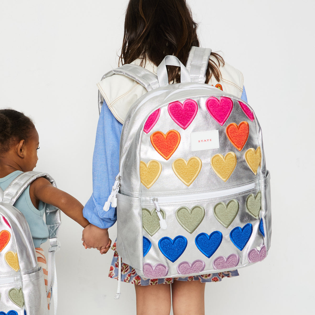 state bags kane kids double pocket backpack metallic fuzzy/hearts lifestyle view click to zoom