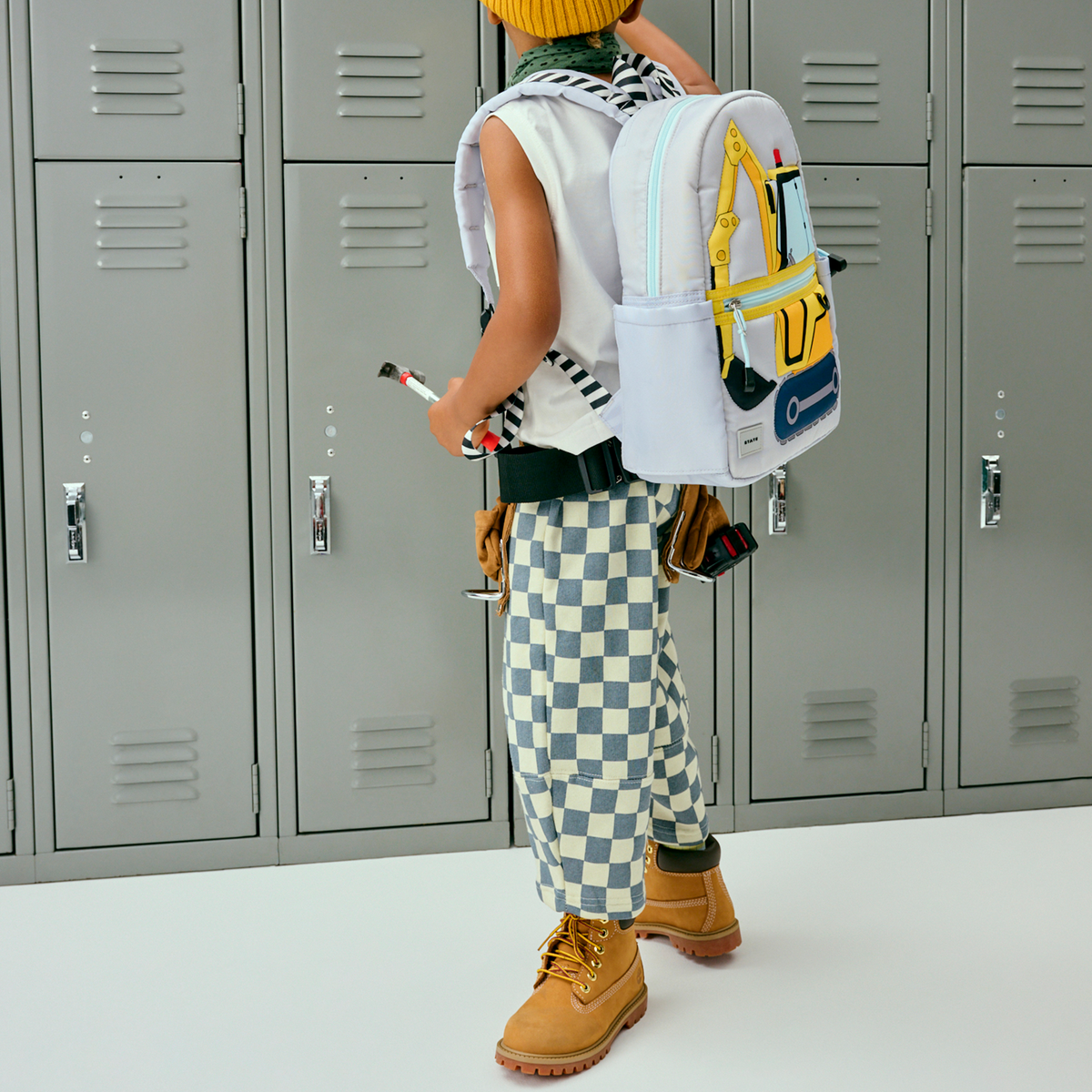 boy wearing STATE Kane Mini Backpack construction