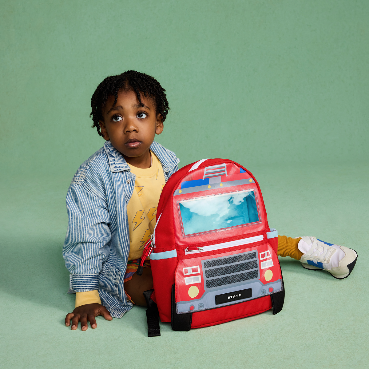 boy holding state bags kane mini firetruck