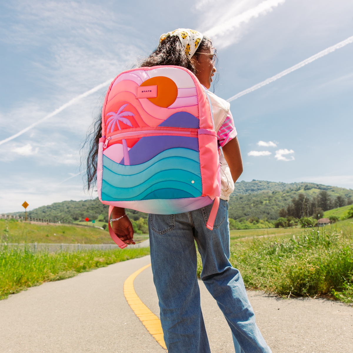 girl wearing sunset backpack